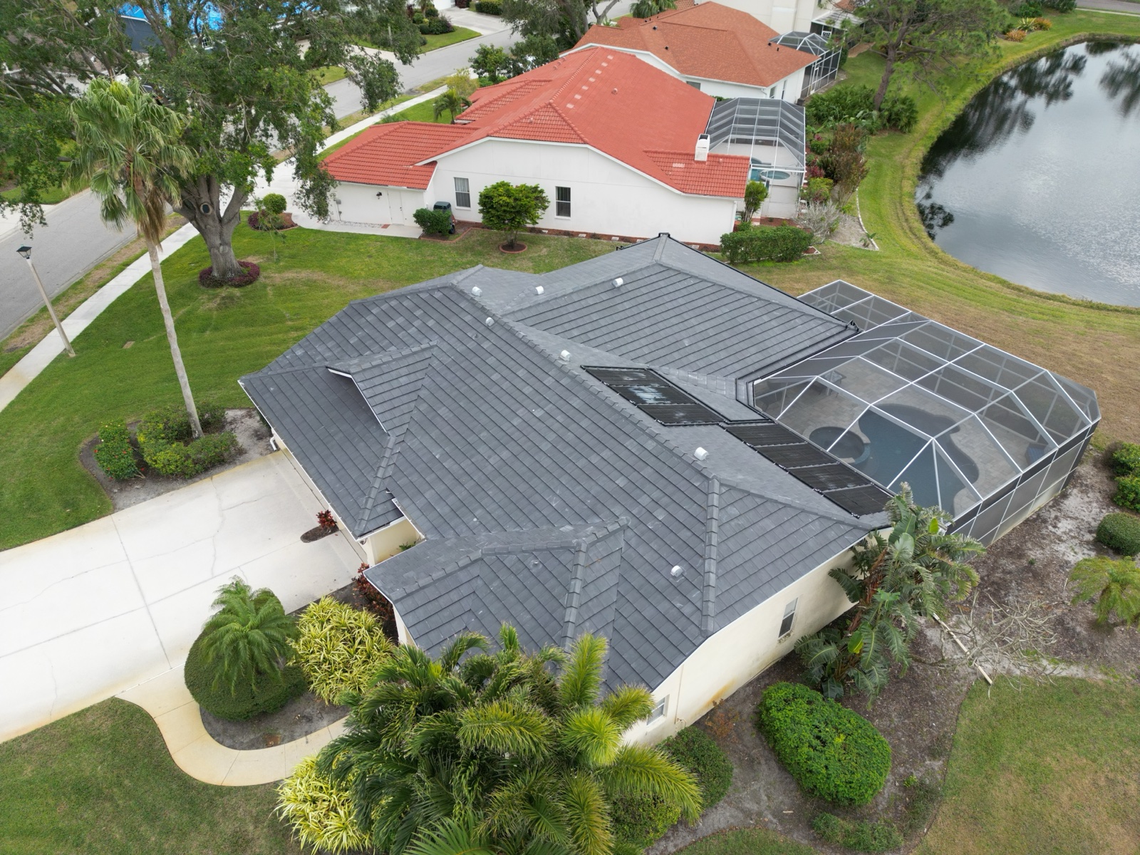 New dark tile roof on a Sarasota home with pool enclosure